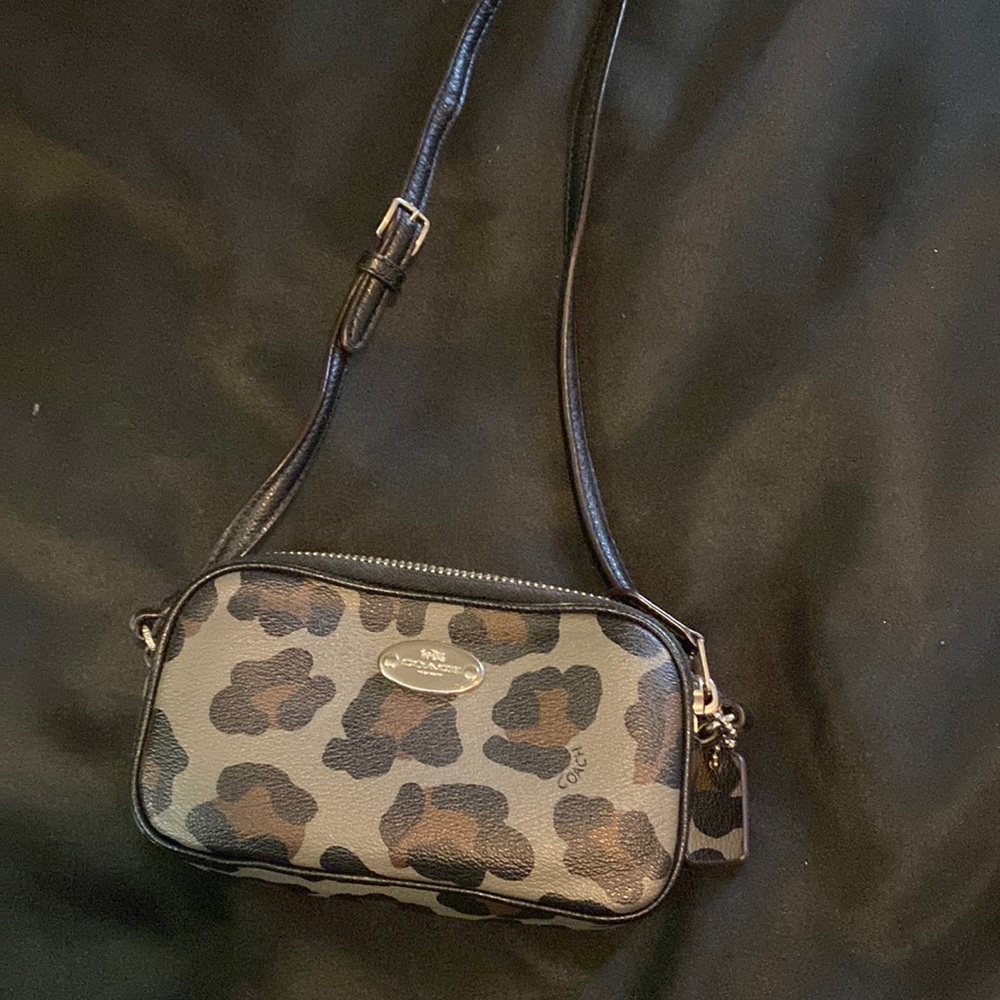 Mini Coach-crossbody purse with animal print design.